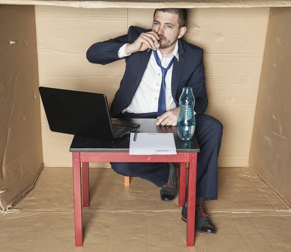 Businessman drinking alcohol during working hours