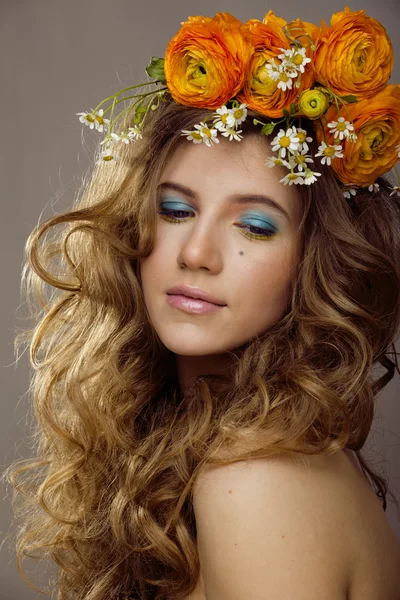 Beauty young woman with flowers and make up close up, real spring beauty girl