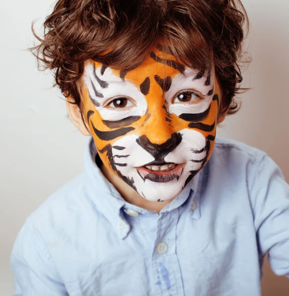 Little cute boy with faceart on birthday party close up, little cute tiger