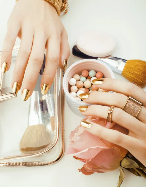 Woman hands with golden manicure