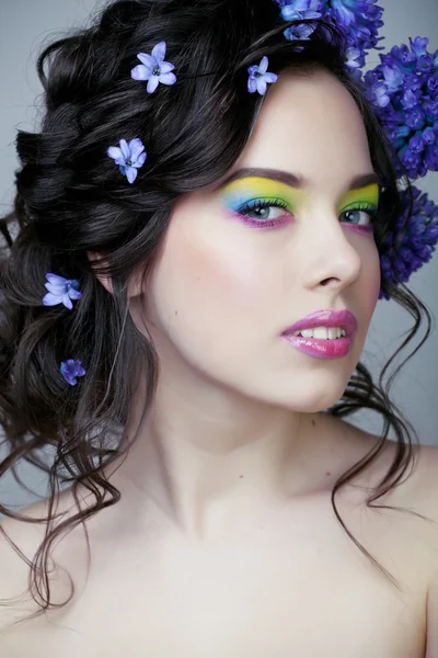 Beauty young woman with flowers and make up close , real spring  girl floral