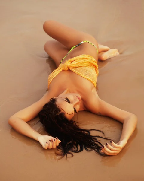 Pretty young girl on beach laying