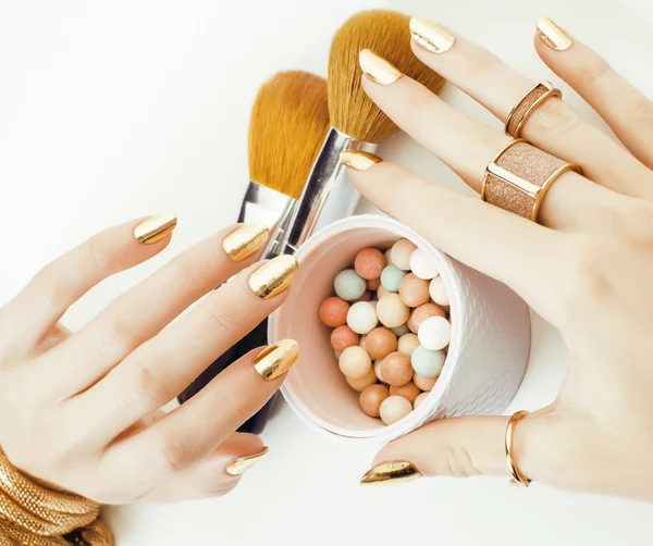 Golden manicure and many rings