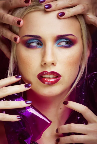 Beauty woman with creative make up, many fingers on face close up