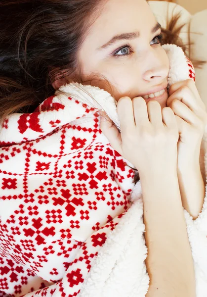 Yong pretty brunette girl in Christmas ornament blanket getting warm on cold winter, freshness beauty concept