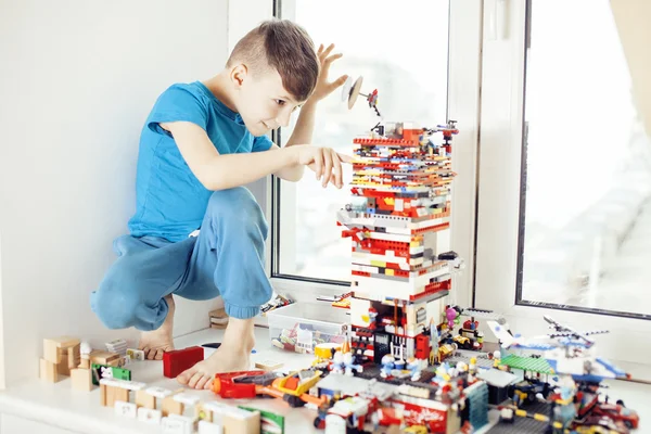 Little cute preschooler boy playing lego toys at home happy smiling, lifestyle children concept