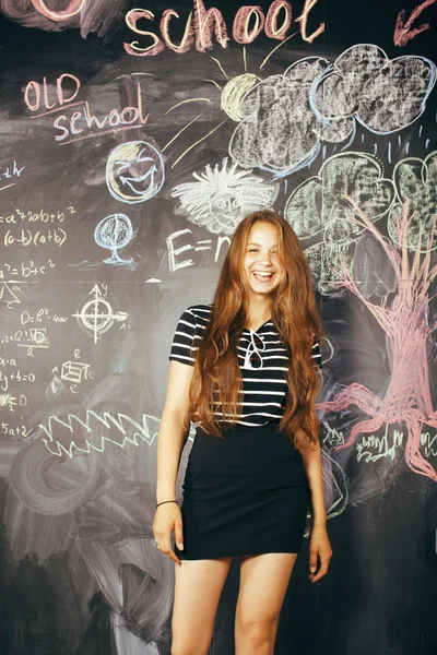 Back to school after summer vacations, cute teen real girl in classroom