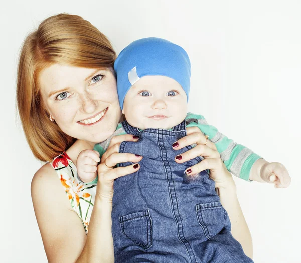 Young beauty mother with cute baby, red head happy modern family isolated on white background close up, lifestyle people concept