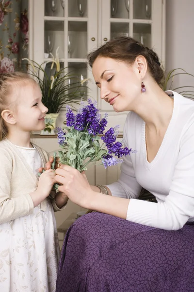 Young mother with daughter at luxury home interior vintage