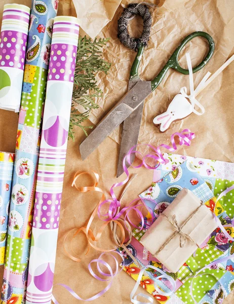 Lot of stuff for handmade gifts, scissors, ribbon, paper with countryside pattern, ready for holiday concept, nobody home