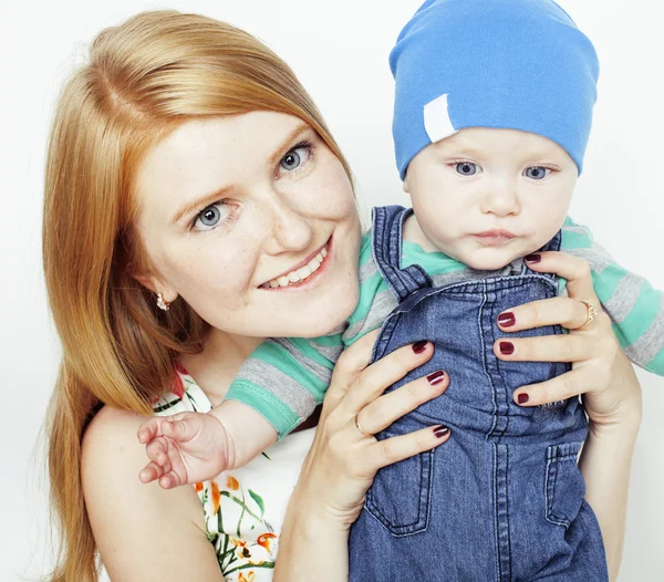 Young beauty mother with cute baby, red head happy modern family isolated on white background close up, lifestyle people concept