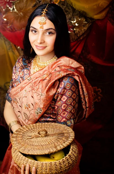 Beauty sweet real indian girl in sari smiling on black background