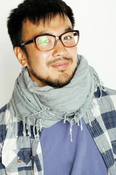 Young handsome asian man hipster in glasses on white background smiling, modern lifestyle concept
