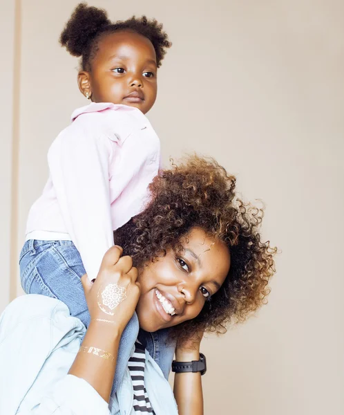 Adorable sweet young afro-american mother with cute little daughter