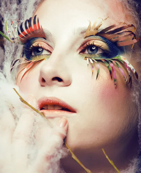 Woman with creative make up closeup like butterfly, summer trend big lashes, halloween makeup, holiday people image concept