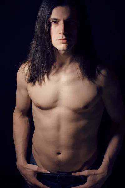 Handsome young man with long hair naked torso