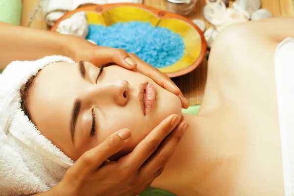 Stock photo attractive lady getting spa treatment in salon, close up asian hands on face