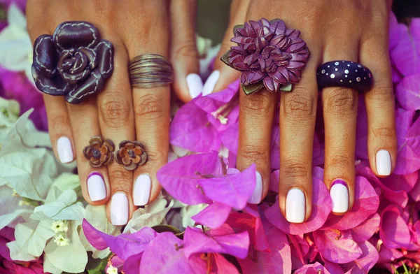 Bright colorfull shot of african tanned hands with manicure amon