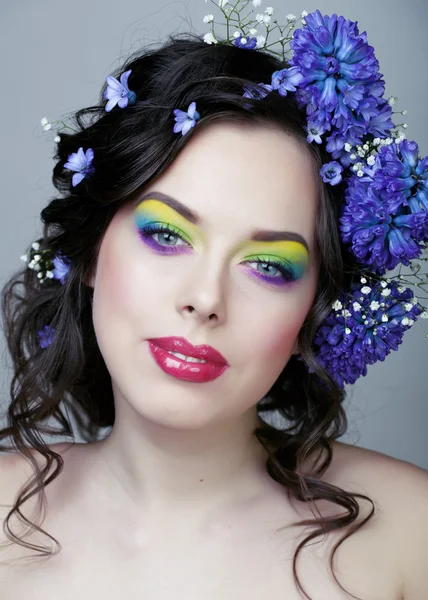 Beauty young woman with flowers and make up closeup, real spring beauty girl floral