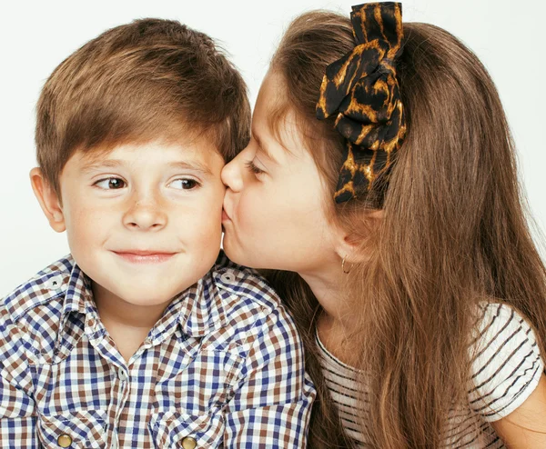 Little cute boy and girl hugging playing on white background, happy family