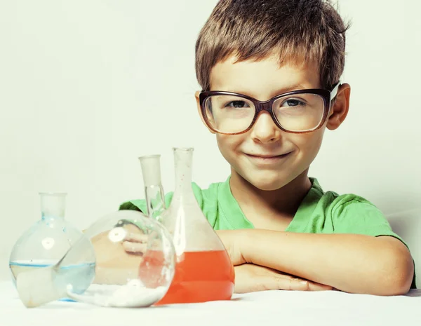 Little cute boy with medicine glass isolated wearing glasses smiling