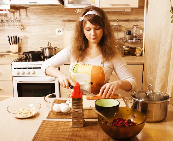 Pretty young woman on kitchen preparing dinner