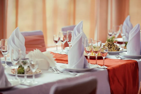 Served tables on wedding dinner in restaurant, food glasses empty