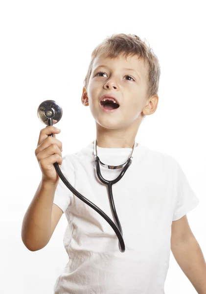 Little cute boy with stethoscope playing like adult profession doctor close up isolated on white