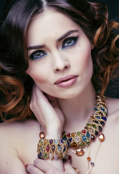 Beauty rich woman with luxury jewellery looks like mature