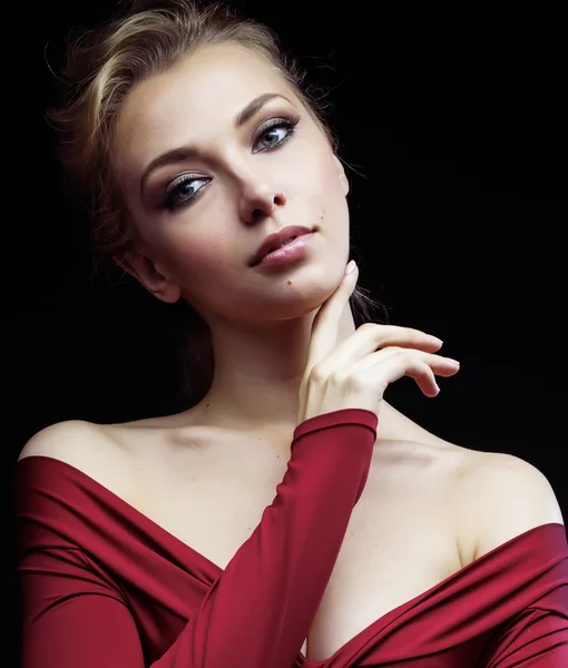 Beautiful rich blond woman in elegant dress on black background close up