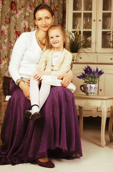 Young mother with daughter at luxury home interior vintage