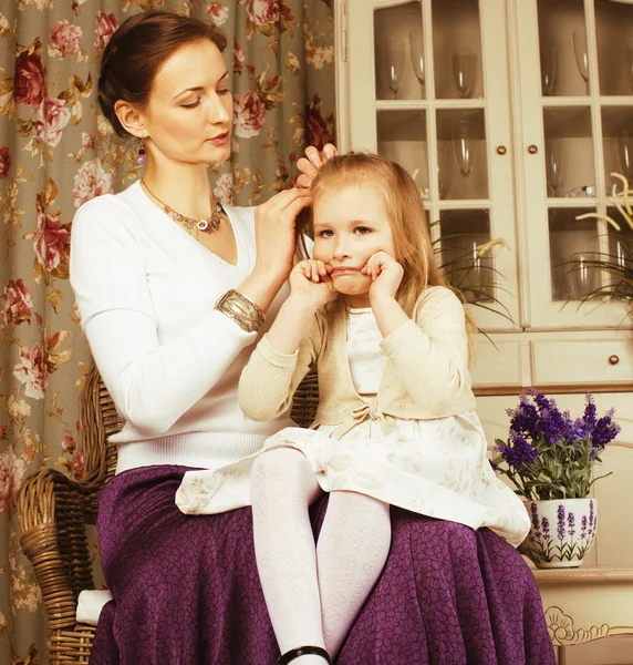 Young mother with daughter at luxury home interior vintage