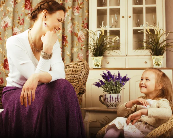 Young mother with daughter at luxury home interior vintage