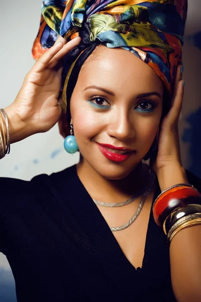 Beauty bright african american woman with creative make up, shawl on head like cubian closeup