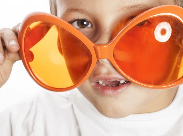 Little cute boy in orange sunglasses pointing isolated close up part of face
