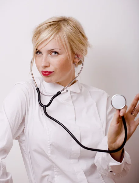 Funny doctor with stethoscope, smiling blond woman medical equipment