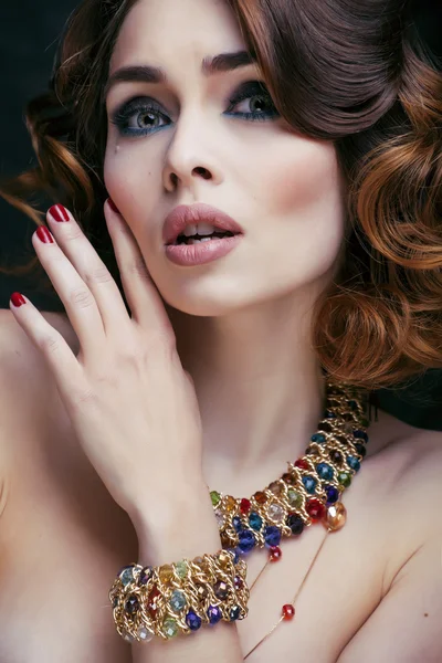 Beauty rich woman with luxury jewellery looks like mature close up