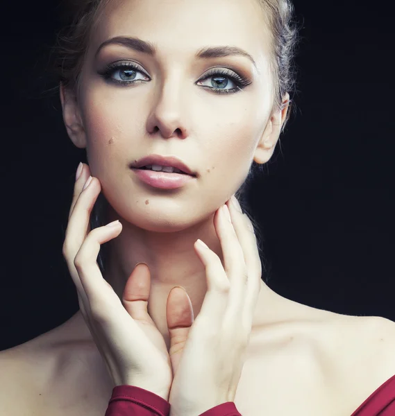 Beautiful rich blond woman in elegant dress on black background close up