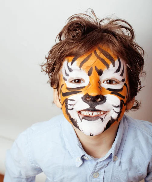 Little cute boy with faceart on birthday party close up, little cute tiger