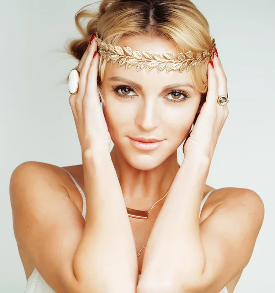 Young blond woman dressed like ancient greek godess, gold jewelry close up isolated