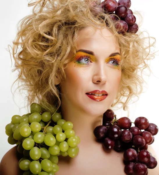 Beautiful young woman portrait excited smile with fantasy art hair makeup style, fashion girl with creative food fruit orange, grapes, citrus make up, happy looking at camera isolated white background