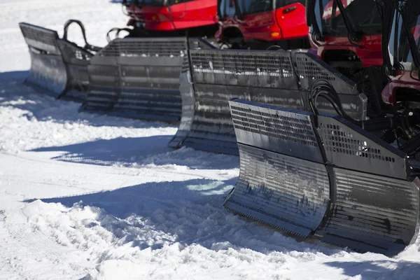 Details of a group of Snow-grooming machine on snow hill ready f