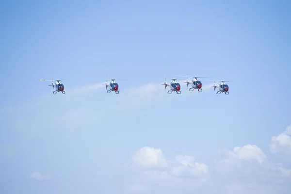 GRANADA,SPAIN - May 18: Aerobatic Spanish helicopter patrol (ASPA Patrol) perform at airshow (10 Aanniversary of Aspa Patrol in Granada) on May 18, 2014 in Granada ,Spain