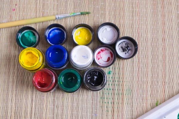 Top view of opened bottles of poster paint