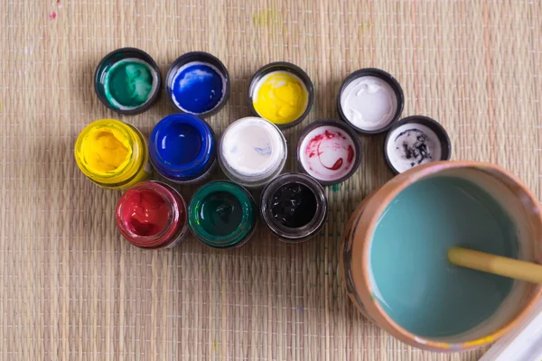 Top view of opened bottles of poster paint