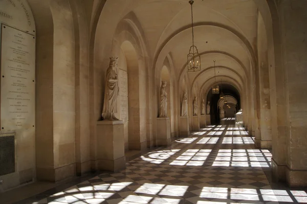 Empty corridor with marble statues Palace of Versailles
