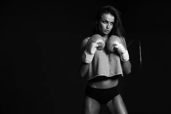 Young sexy girl with boxing gloves.