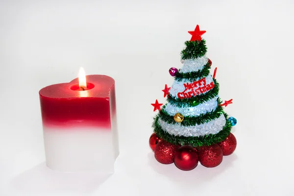 Christmas tree with heart candle on the white background