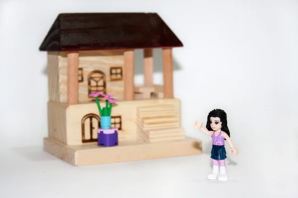 Wooden house and plastic toys