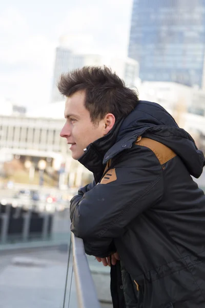 Young handsome guy on the street in a black jacket